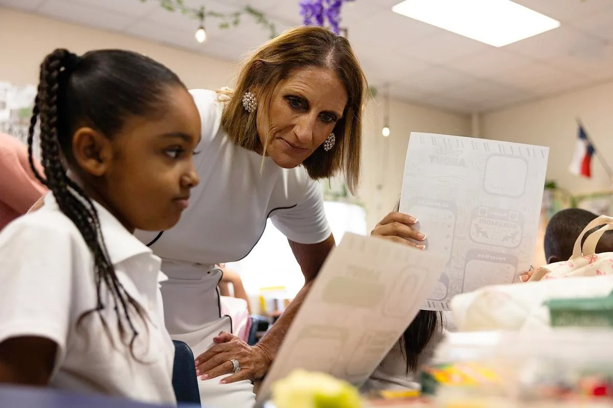Superintendent Karen Molinar reads over an ice breaker assignment in a classroom at Mary Louise Phillips Elementary in Fort Worth during FWISD's first day of school. Molinar, who will leave her position in the coming weeks amid a state takeover of the district, is one of several North Texas superintendents departing their posts.