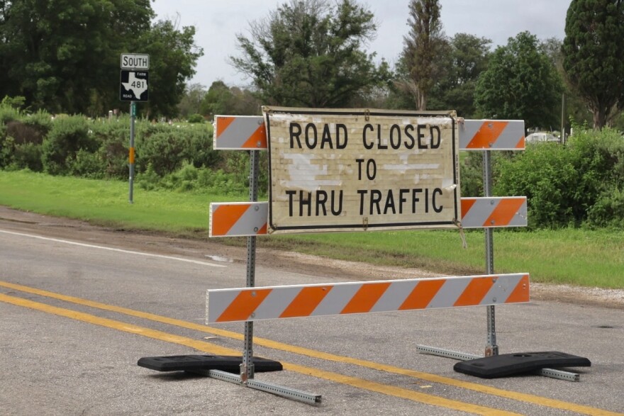 A road block ahead of the FM 481 bridge in Uvalde which has been partly destroyed by flooding along the Nueces River.