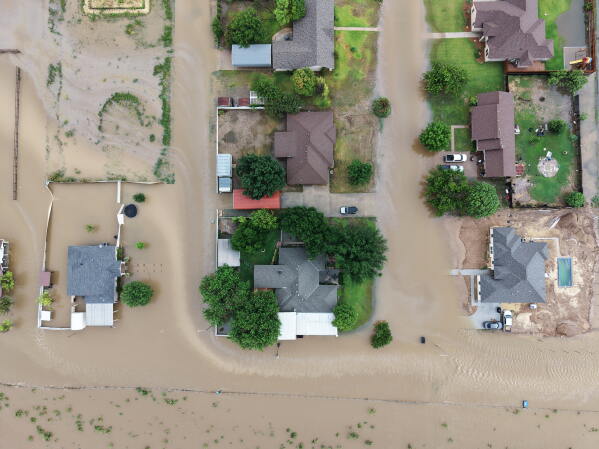 An aerial view shows flooding on Friday, July 17, 2026, in Ozona, Texas. (AP Photo/Gerald Herbert)