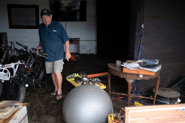 Bob Bettes assesses damage to his belongings after flooding reached the Buckhorn Lake Resort RV Park along West Goat Creek near the Guadalupe River on Friday, July 17, 2026, in Kerrville, Texas. (AP Photo/Joel Angel Juarez)