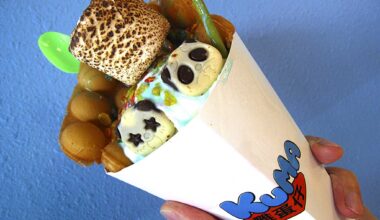Hong Kong-style bubble waffle ice cream cone with unicorn ice cream, Fruity Pebbles, a toasted marshmallow and more from Kuma.