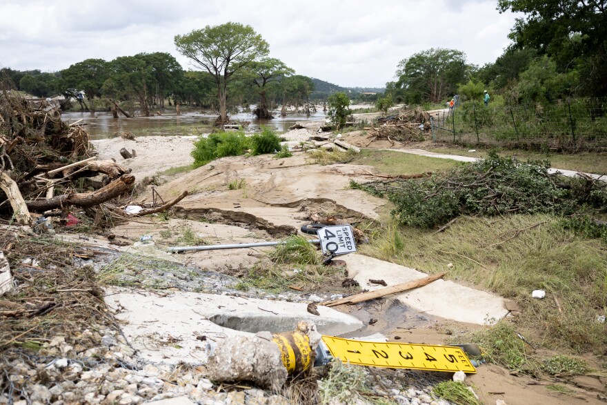 Debris, included a 40 mph speed limit signs and a broken flood gauge, in Town Creek on Francisco Lemos Street in Kerrville on Friday, July 17, 2026.