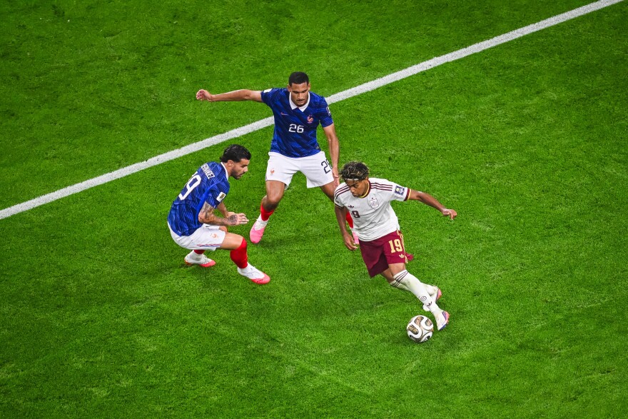 Spain's Lamine Yamal (19) drives the ball around France's Theo Hernandez (19) and France's Maxence Lacroix (26) during the World Cup semifinal soccer match in Arlington, Texas, near Dallas, Tuesday, July 14, 2026. (AP Photo/Jessica Tobias)
