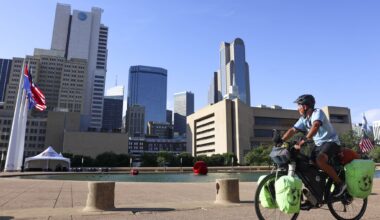 Juan Miguel Silio, 56, looks toward the Dallas skyline following his break at the Akard Plaza, on Thursday, May 14, 2026, in Dallas. 