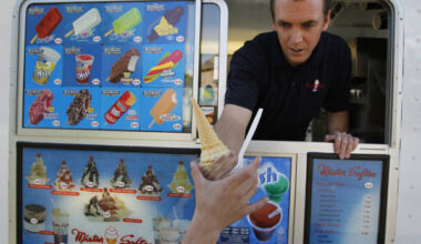 Patrick Haile with his Mr. Softee ice cream truck hands off a chocolate cone to a customer in Southlake.