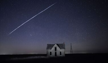 FILE - In this long exposure photo, a string of SpaceX StarLink satellites passes over an old stone house near Florence, Kan., on May 6, 2021. (AP Photo/Reed Hoffmann, File)