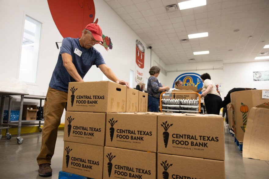 Chris Lehecka, Central Texas Food Bank volunteer moves boxes during his volunteer shift in North Austin on Nov. 12, 2024. Patricia Lim/KUT News