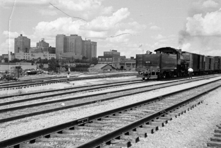 Texas and Pacific's "Louisiana Limited" train No. 2-22, eastbound, headed by Engine No. 702, a Pacific type 4-6-2 locomotive, leaving Fort Worth on a summer afternoon at sundown.