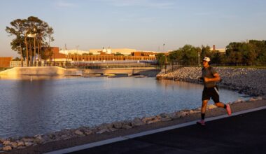 A man runs along a new trail in front of the new Bachman Lake spillway in Dallas, Monday, April 6, 2026.