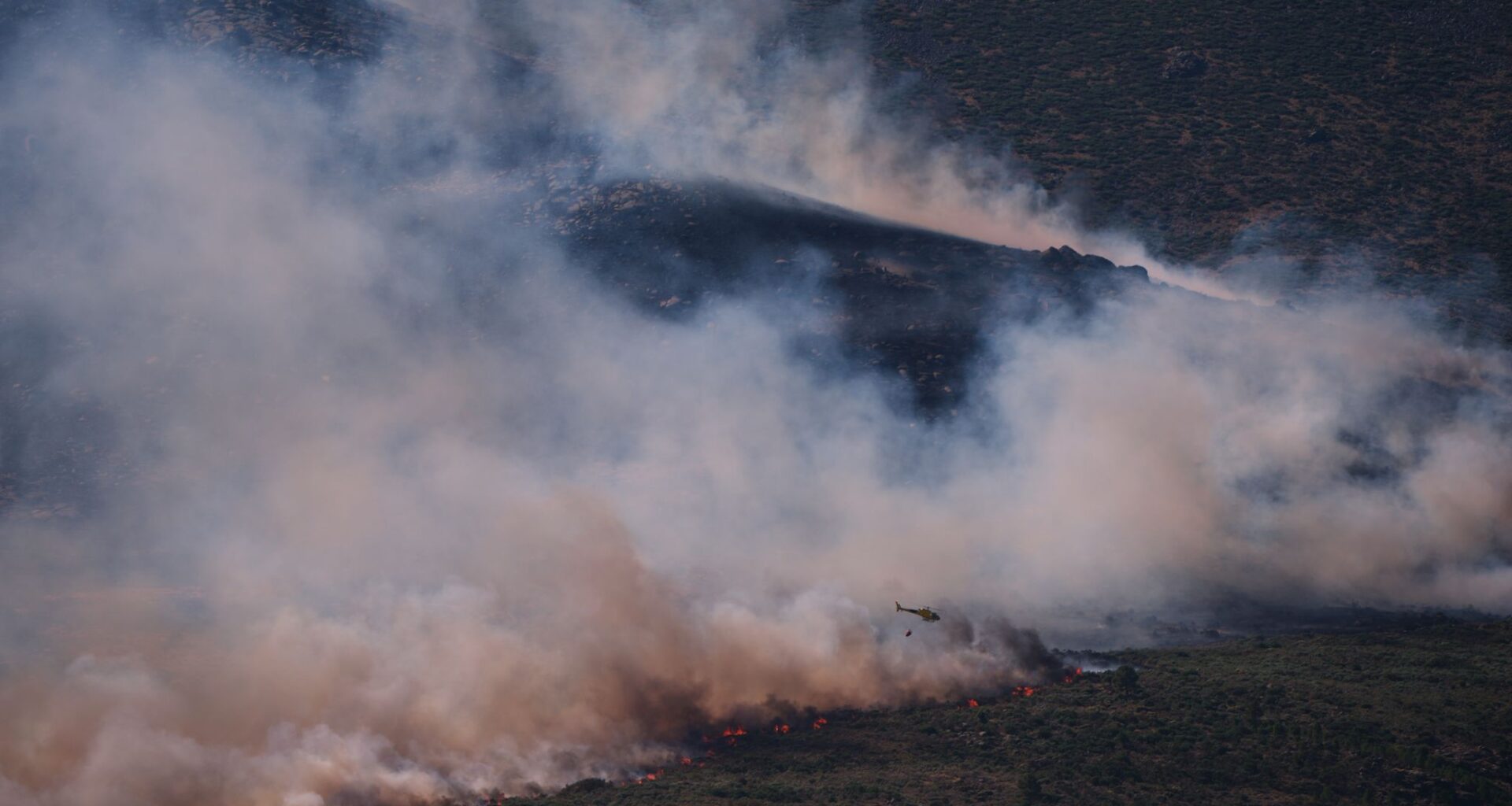 Tens of thousands of people flee raging wildfires in France and Spain, some escaping by boat