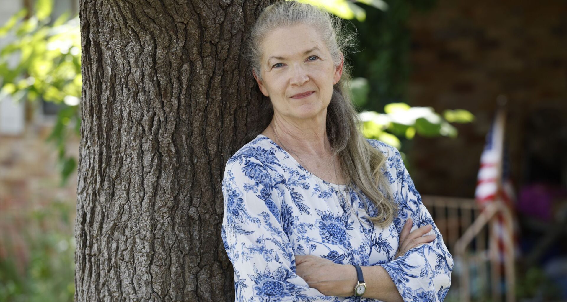 Grace Barber, 65, a retired nurse and teacher, poses for a photo in front of the house where she lives with her daughter, Wednesday, July 22, 2026, in Dallas.
