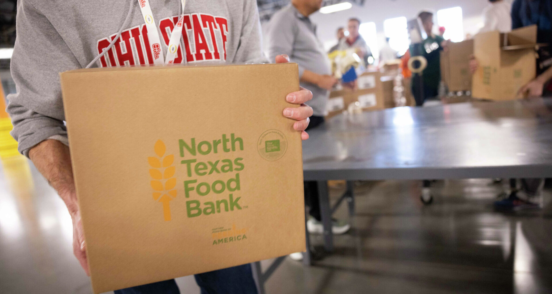 Volunteers representing Ohio State University and the University of Miami pack food at the North Texas Food Bank in Plano on Tuesday, Dec. 30, 2025.
