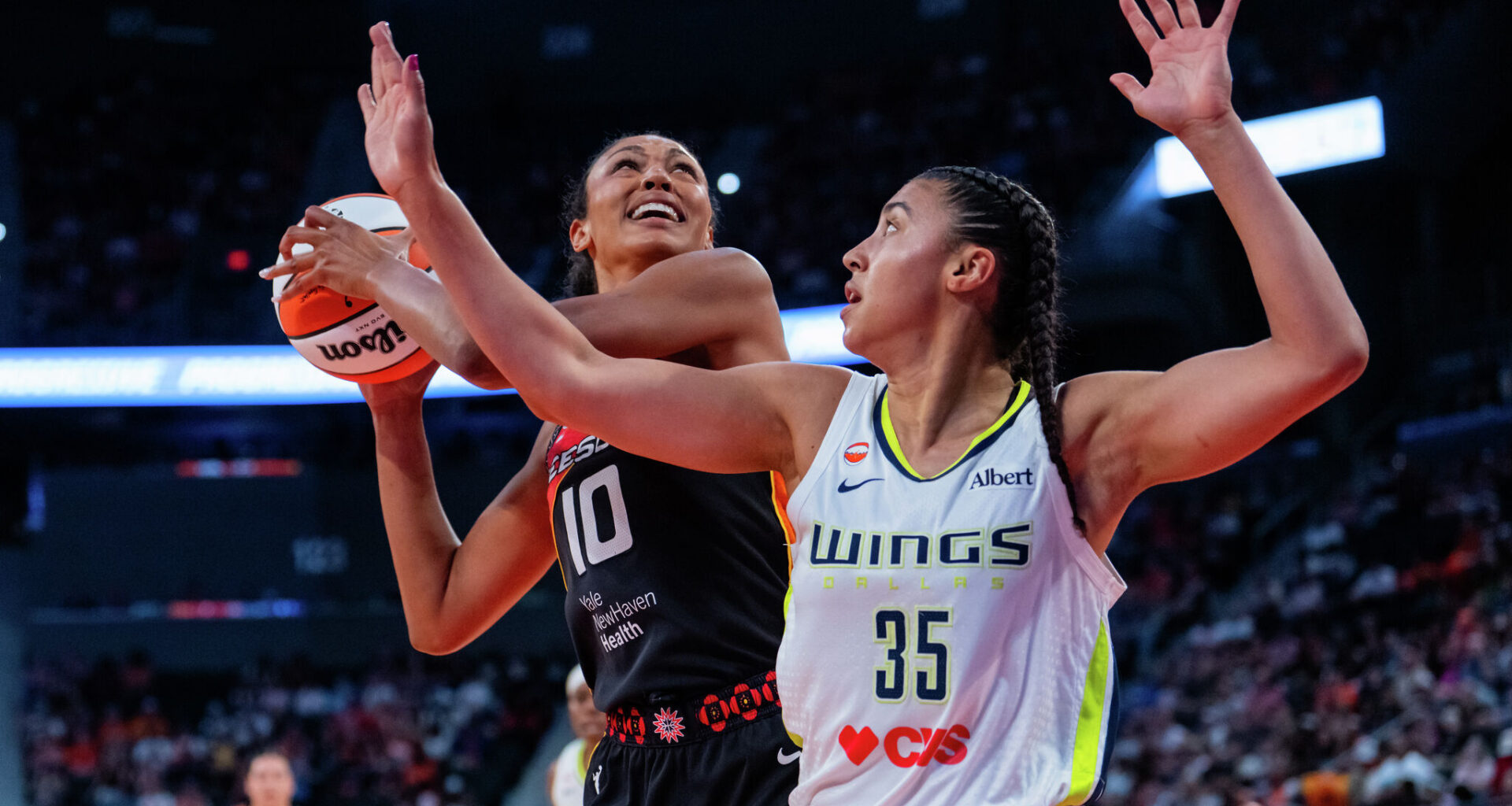 ARLINGTON, TEXAS - JULY 19: Paige Bueckers #5 of the Dallas Wings is defended by Erica Wheeler #17 of the Los Angeles Sparks.