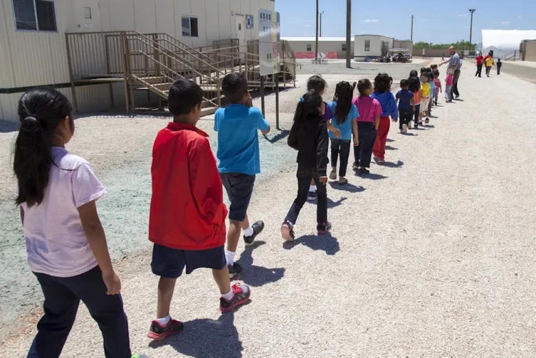Children walk between structures at the Dilley detention camp during Trump's first term in office.