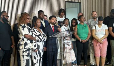 Sean Daredia, who represents Daniel Erving's family, speaks next to Erving's mother and aunt at a news conference on July 13, 2026. 