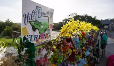 A Hill Country Strong sign is pictured among flowers, photos, notes, and toys for victims of the July Fourth flooding at the memorial wall on Thursday, July 17, 2025, in Kerrville, Texas.