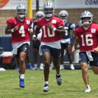 Jul 29, 2026; Oxnard, CA, USA; Dallas Cowboys quarterbacks Dak Prescott (4), Joe Milton (10) and Sam Howell (16) run at training camp at River Ridge Playing Fields.