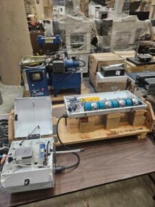 Blue power line sensor sits on a wooden table in a lab.