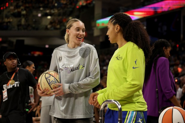 Former UConn stars Paige Bueckers, left, and Azzi Fudd chat during the WNBA Skills Challenge 3-Point Contest on Friday night in Chicago. (Geoff Stellfox/Getty Images)