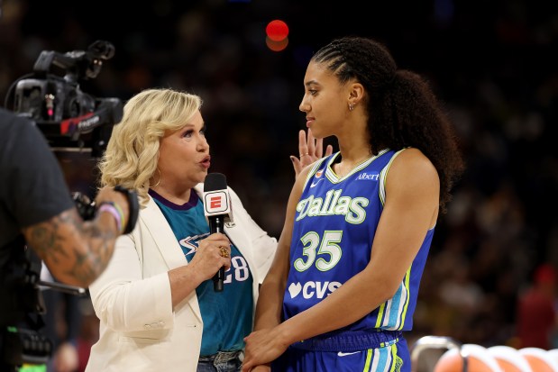 Former UConn star and current Dallas Wings rookie Azzi Fudd is interviewed during the WNBA three-point shooting contest in Chicago on Friday. Fudd edged Portland's Bridget Carleton to win the title. (Geoff Stellfox/Getty Images)