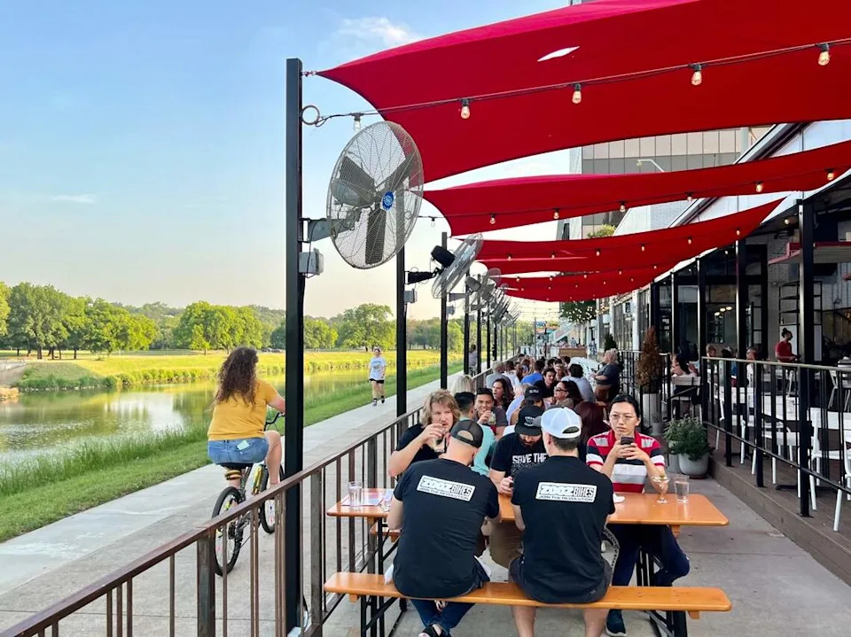 The patios at HG Sply Co., Quince and Ascension Coffee hug the Trinity Trail near the Fort Worth Zoo and Colonial Country Club May 22, 2023.