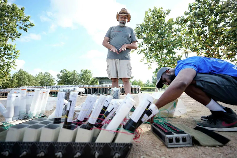 Johnathan Smith, left, and Kadeem Anderson, both with Pyrotecnico, install wiring during fireworks prep at The Water Works in Buffalo Bayou Park for the Freedom Over Texas in Houston Friday, July 3, 2026. (Melissa Phillip/Houston Chronicle)