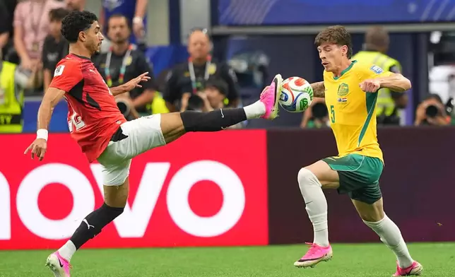 Egypt's Omar Marmoush, left, and Australia's Jordan Bos vie for the ball during a World Cup round of 32 soccer match in Arlington, Texas, near Dallas, Friday, July 3, 2026. (AP Photo/Julio Cortez)