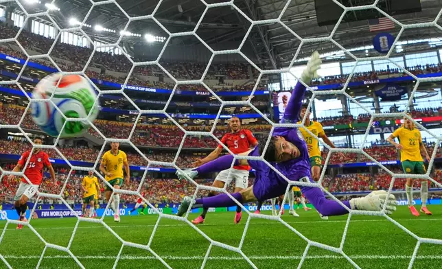 Egypt's Emam Ashour (8) scores the opening goal past Australia goalkeeper Patrick Beach (18) during the World Cup round of 32 soccer match between Australia and Egypt in Arlington, Texas, near Dallas, Friday, July 3, 2026. (AP Photo/Julio Cortez)