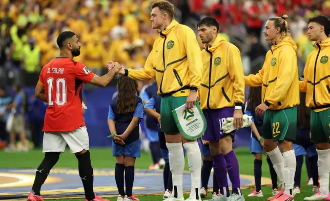 Egypt's Mohamed Salah (10) shakes hands with Australia's Harry Souttar (19) before the World Cup round of 32 soccer match between Australia and Egypt in Arlington, Texas, near Dallas, Friday, July 3, 2026. (AP Photo/Gareth Patterson)