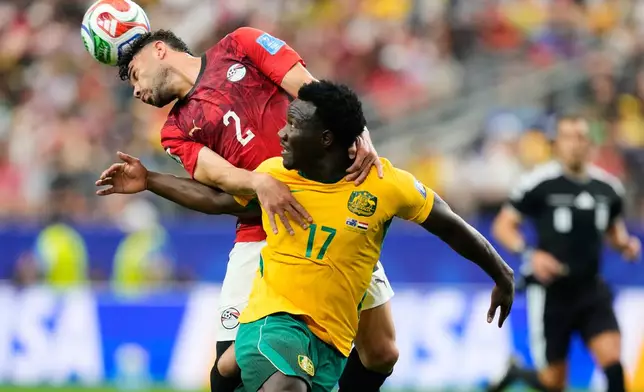 Egypt's Yasser Ibrahim (2) and Australia's Nestory Irankunda fight for the ball during the World Cup round of 32 soccer match in Arlington, Texas, near Dallas, Friday, July 3, 2026. (AP Photo/Tony Gutierrez)