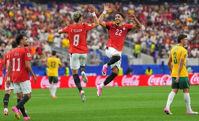 Egypt's Emam Ashour (8) celebrates with Omar Marmoush after scoring the opening goal during a World Cup round of 32 soccer match between Australia and Egypt in Arlington, Texas, near Dallas, Friday, July 3, 2026. (AP Photo/Julio Cortez)
