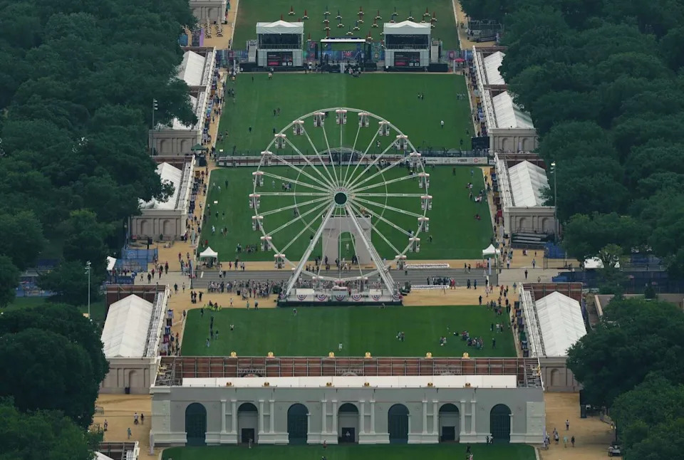A ferris wheel anchors the National Mall on Friday during the Great American State Fair, lined with tourist attractions and structures for state promotional displays. (Carolyn Kaster/Associated Press)