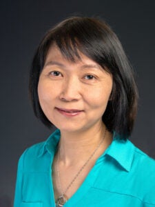 headshot of a woman wearing a teal collared shirt