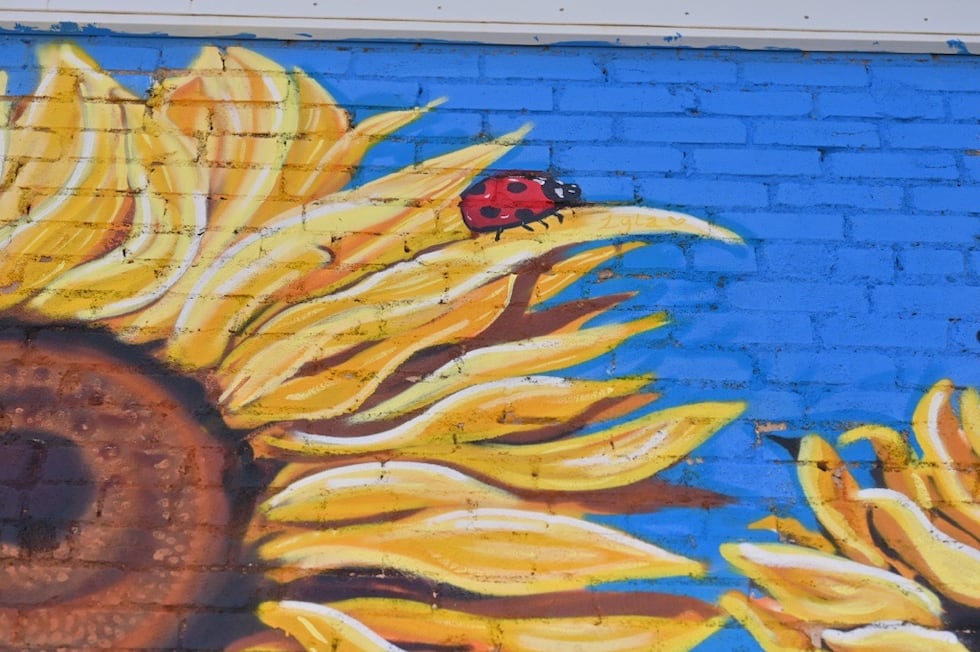 On one of the mural’s leaves, a ladybug sits above a small gold inscription that reads - "Lyla."