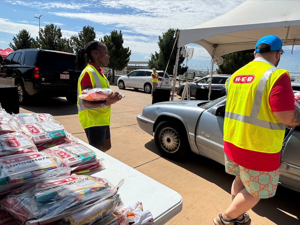 H-E-B brought its trucks to the South Plains Food Bank on Saturday to distribute bags of food...