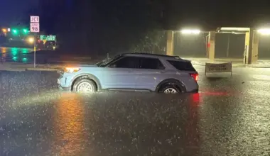 A vehicle sits stranded in high water in Kerrville, Texas, early Tuesday, July 14, 2026, as heavy rain caused flooding across parts of the Texas Hill Country.