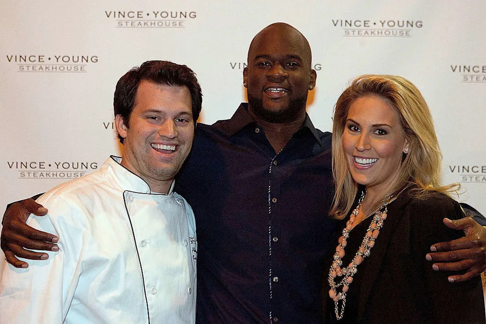 (L-R) Phillips Brown, Vince Young and Laura McIngvale Brown attend the opening of the Vince Young Steakhouse on November 5, 2010 in Austin, Texas. (Sarah Kerver/WireImage)