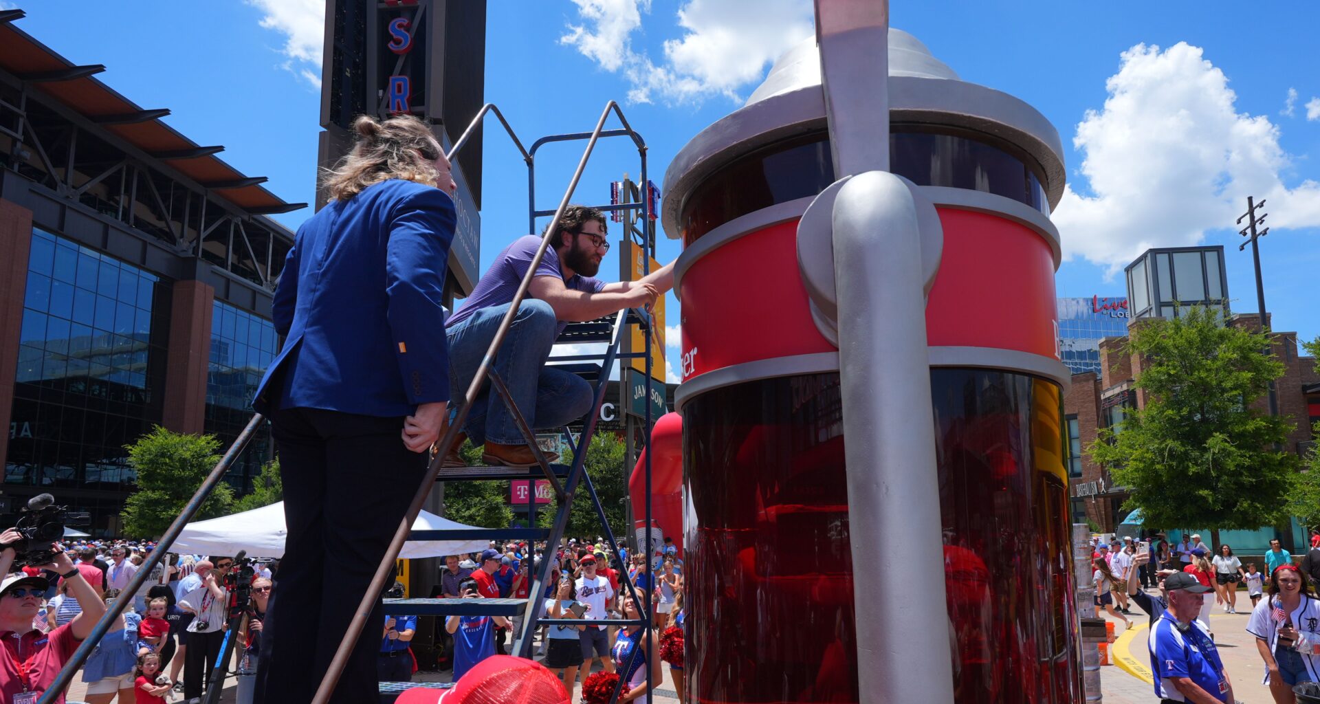 Eric Johnson and Guinness World Records adjudicator Thomas Bradford check the level of beer before certifying a world record for Largest Glass of Beer ahead of a baseball game between the Detroit Tigers and Texas Rangers, Saturday, July 4, 2026, in Arlington, Texas. (AP Photo/LM Otero)