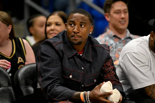May 28, 2026; Arlington, Texas, USA; Dallas Cowboys player Donovan Ezeiruaku watches the game between the Dallas Wings and the Las Vegas Aces at College Park Center. Mandatory Credit: Jerome Miron-Imagn Images