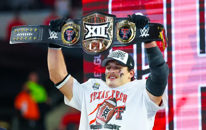 Dec 6, 2025; Arlington, TX, USA;  Texas Tech Red Raiders linebacker Ben Roberts (13) celebrates with the Big 12 WWE Championship belt after the game against the BYU Cougars at AT & T Stadium. Mandatory Credit: Kevin Jairaj-Imagn Images
