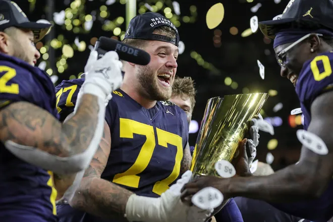 Michigan offensive lineman Trevor Keegan celebrate 34-13 win over Washington at the national championship game at NRG Stadium in Houston on Monday, Jan. 8, 2024.