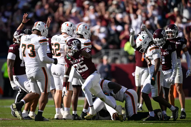 Dec 20, 2025; College Station, TX, USA; Texas A & M Aggies safety Dalton Brooks (25) reacts after stripping the ball from Miami Hurricanes wide receiver Malachi Toney (10) during the second half of the first round game of the CFP National Playoff at Kyle Field. Mandatory Credit: Jerome Miron-Imagn Images
