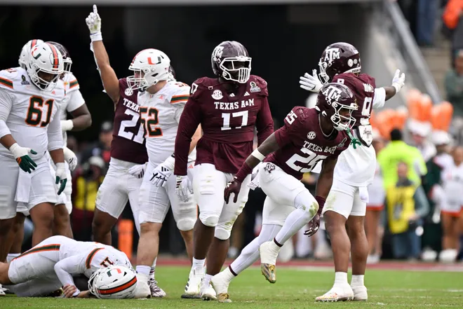 Dec 20, 2025; College Station, TX, USA; Texas A & M Aggies safety Dalton Brooks (25) and Texas A & M Aggies linebacker Taurean York (21) celebrated after sacking Miami Hurricanes quarterback Carson Beck (11) during first half of the first round game of the CFP National Playoff at Kyle Field. Mandatory Credit: Jerome Miron-Imagn Images