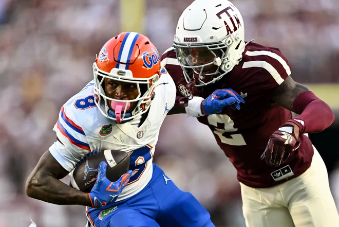 Oct 11, 2025; College Station, Texas, USA; Florida Gators wide receiver Vernell Brown III (8) runs the ball against Texas A & M Aggies cornerback Dezz Ricks (2) during the first half at Kyle Field. Mandatory Credit: Maria Lysaker-Imagn Images