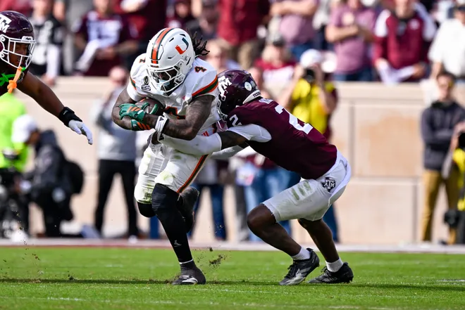 Dec 20, 2025; College Station, TX, USA; Texas A & M Aggies cornerback Dezz Ricks (2) tackles Miami Hurricanes running back Mark Fletcher Jr. (4) during the game between the Aggies and the Hurricanes at Kyle Field. Mandatory Credit: Jerome Miron-Imagn Images