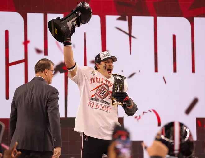 Texas Tech's Ben Roberts lifts the hardware after being named the most outstanding player of the Big 12 Championship football game, Saturday, Nov. 6, 2025, at AT & T Stadium in Arlington.