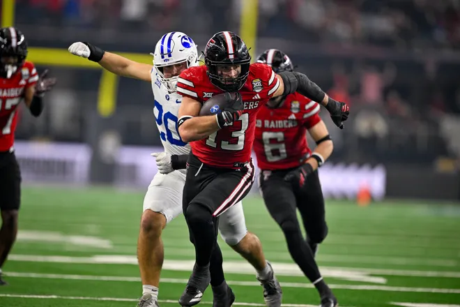 Dec 6, 2025; Arlington, TX, USA; Texas Tech Red Raiders linebacker Ben Roberts (13) returns an interception during the game between the Red Raiders and the Cougars at AT & T Stadium. Mandatory Credit: Jerome Miron-Imagn Images