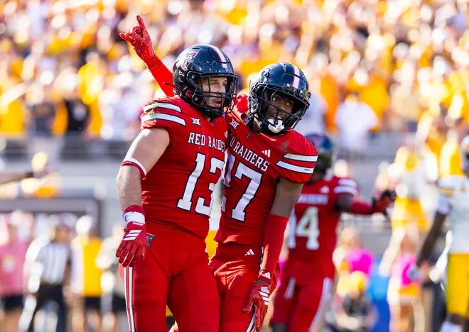 Oct 18, 2025; Tempe, Arizona, USA; Texas Tech Red Raiders linebacker Ben Roberts (13) celebrates a play with cornerback Amier Boyd (27) against the Arizona State Sun Devils at Mountain America Stadium. Mandatory Credit: Mark J. Rebilas-Imagn Images