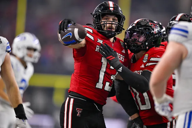 Dec 6, 2025; Arlington, TX, USA; Texas Tech Red Raiders linebacker Ben Roberts (13) and linebacker Jacob Rodriguez (10) celebrates an interception during the game between the Red Raiders and the Cougars at AT & T Stadium. Mandatory Credit: Jerome Miron-Imagn Images
