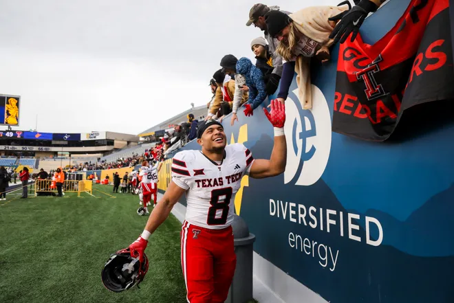 Nov 29, 2025; Morgantown, West Virginia, USA; Texas Tech Red Raiders running back Cameron Dickey (8) celebrates after defeating the West Virginia Mountaineers at Milan Puskar Stadium. Mandatory Credit: Ben Queen-Imagn Images